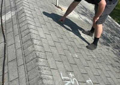 Before look of roof project with signs of shingle damage