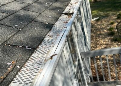 Before look of roof project with signs of shingle damage