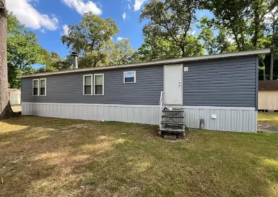 After look of project with GAF Timberline HDZ shingles in Charcoal and CertainTeed MainStreet vinyl siding in Flagstone
