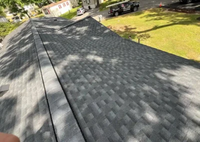 After look of project with GAF Timberline HDZ shingles in Charcoal and CertainTeed MainStreet vinyl siding in Flagstone