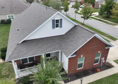 After look of the roof with GAF Timberline HDZ roofing system in Weathered Wood paired with a white aluminum drip edge and upgraded Snow Country ridge vents.
